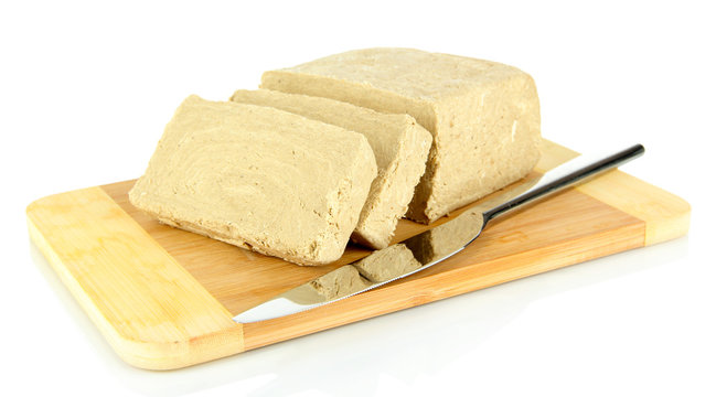 Tasty halva on cutting board isolated on white