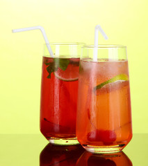 Fototapeta na wymiar Two cherry cocktails with ice on green background