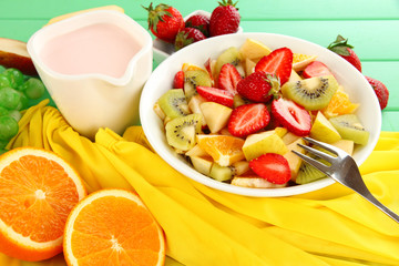 Useful fruit salad of fresh fruits and berries in bowl