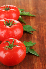 Fresh tomatoes on wooden background