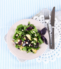 Light salad on plate on napkin