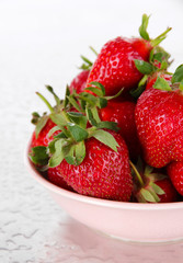 Strawberries in bowl on metal background