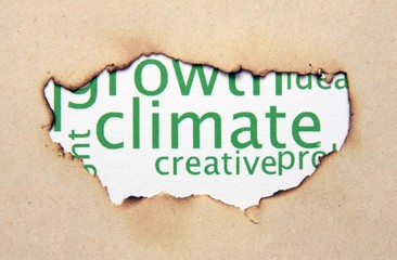 Fototapeta na wymiar Climate text on paper hole