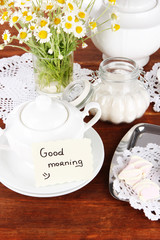 Table setting with chamomiles on wooden table