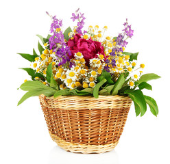 Bouquet of wild flowers in wicker basket, isolated on white