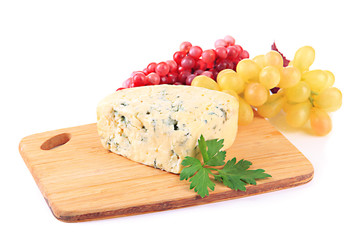 Tasty blue cheese and grape on cutting board, isolated on white