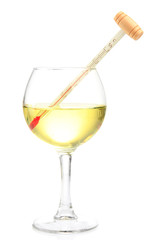 Glass of wine with thermometer, isolated on white