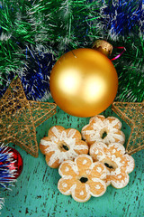 Christmas cookies and decorations on color wooden background