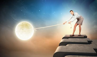 Naklejka premium Woman pulling moon