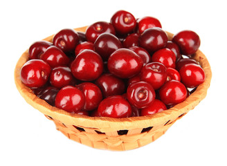 Cherry berries in wicker basket isolated on white
