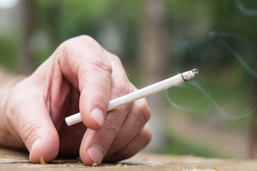 closeup of an cigarette in hand man