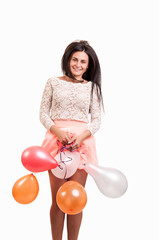 Young happy girl with a bunch of colored balloons