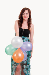 Young happy girl with a bunch of colored balloons