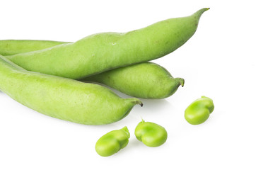 Fresh broad beans and pods close up on white