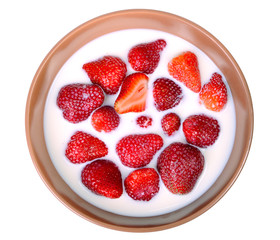Strawberry with milk in a ceramic plate