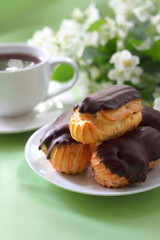 Eclairs with cream in chocolate coating