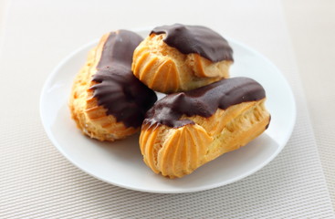Eclairs with cream in chocolate coating