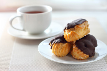 Eclairs with cream in chocolate coating