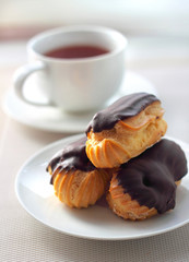 Eclairs with cream in chocolate coating
