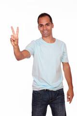 Fototapeta premium Charming young man showing you victory sign