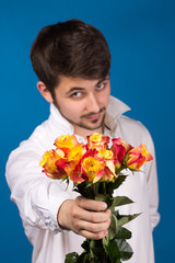 Obraz na płótnie Canvas young man giving a red rose