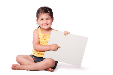 Happy girl sitting pointing at whiteboard