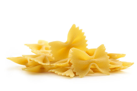heap of bow tie pasta on white background