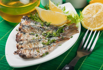 Grilled sardine fish with lemon and lettuce