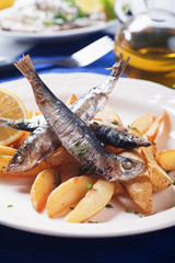 Grilled sardine fish with potato wedges