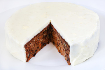Carrot and walnut cake with marzipan icing, piece missing