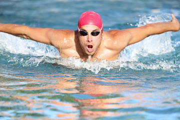 Fototapeta na wymiar Swimmer athletic man swimming butterfly
