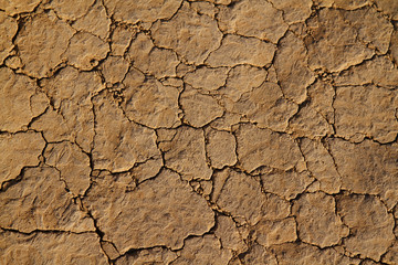 Dry cracked earth and dirt with grains of sand