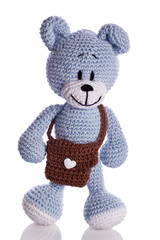 blue teddy bear with brown school bag