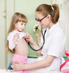 doctor examining girl with stethoscope