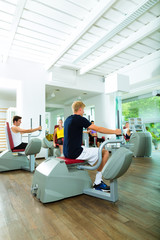 Fototapeta premium People in sport gym on machines