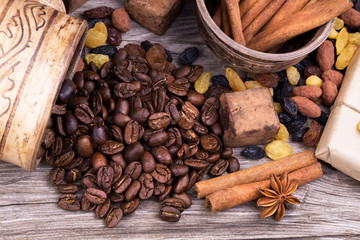 Chocolate bar and spices on wooden table