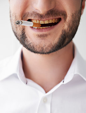 smoking man with dirty yellow teeth