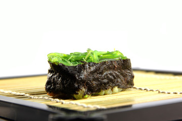 The seaweed Sushi on the dish.