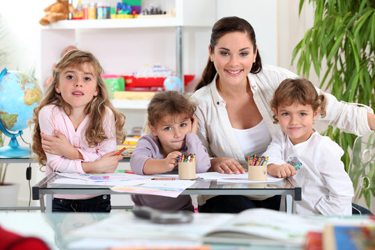 three primary schoolgirls and a teacher