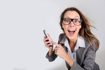 Naklejka premium Business girl with funny look showing smartphone