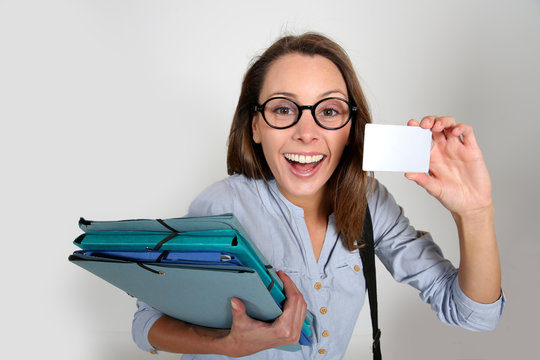 Smiling student girl showing college pass