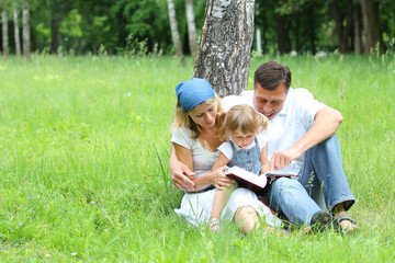 Young family reading the Bible