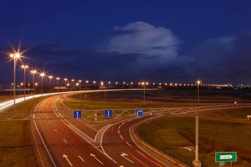Tuinposter Electric lighting on night the highway. © grigvovan