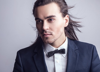 Portrait of handsome long-haired stylish man.