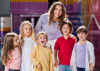 Teacher With Group Of Children In Preschool