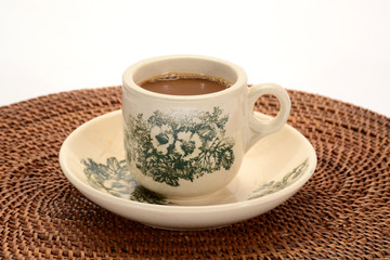A Cup Of Freshly Brewed Coffee On A Table Mat