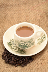 A Cup Of Coffee With Coffee Seeds