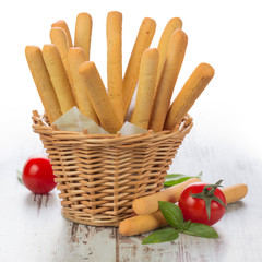 Grissini - fresh breadsticks in a basket on wooden table