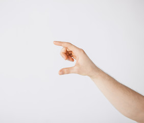 mans hand showing something