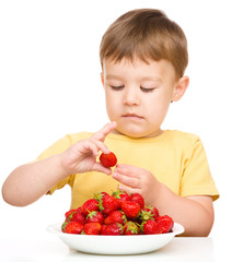 Little boy with strawberries